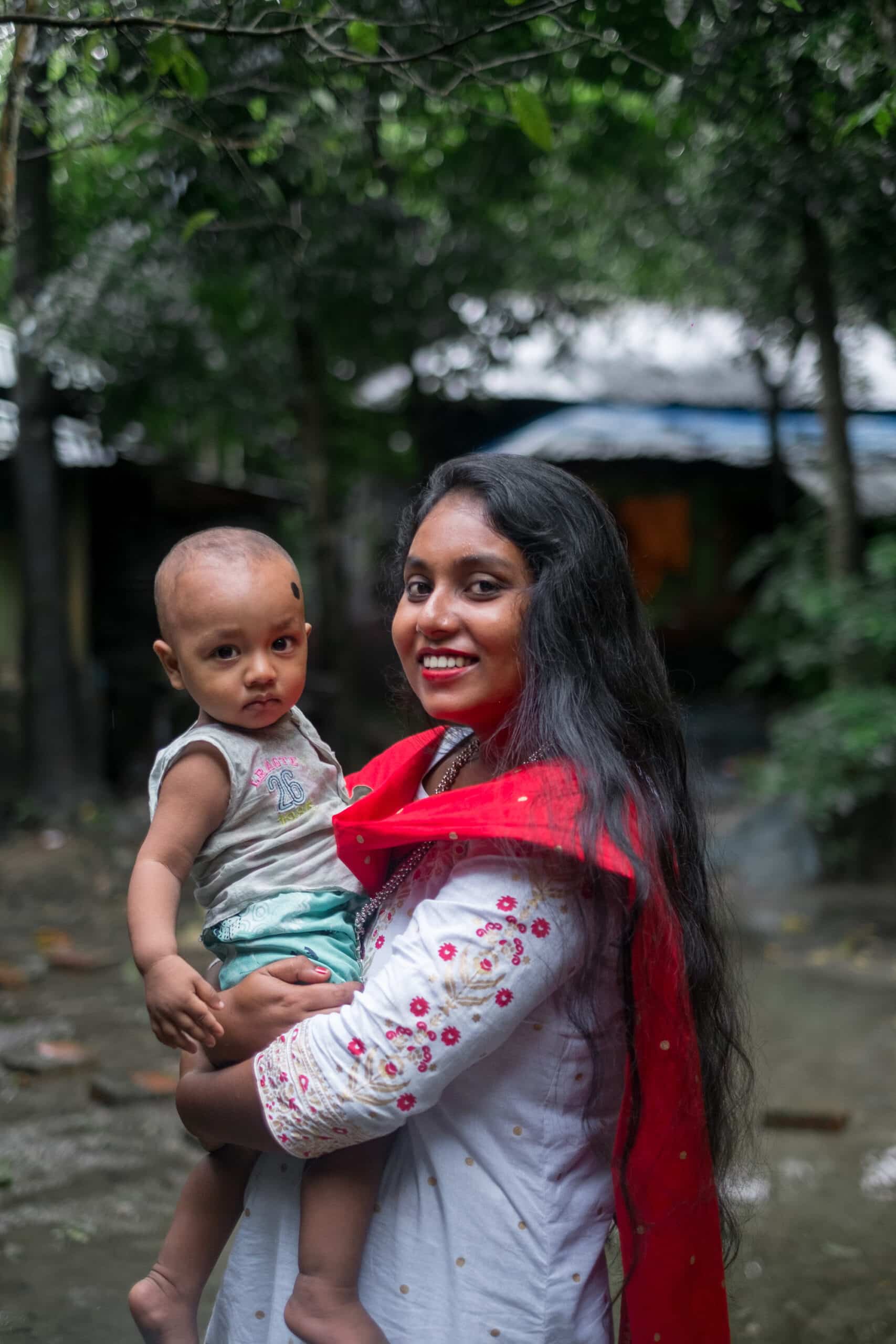 South asian family photo, young mother holding her son, aunt with nephew